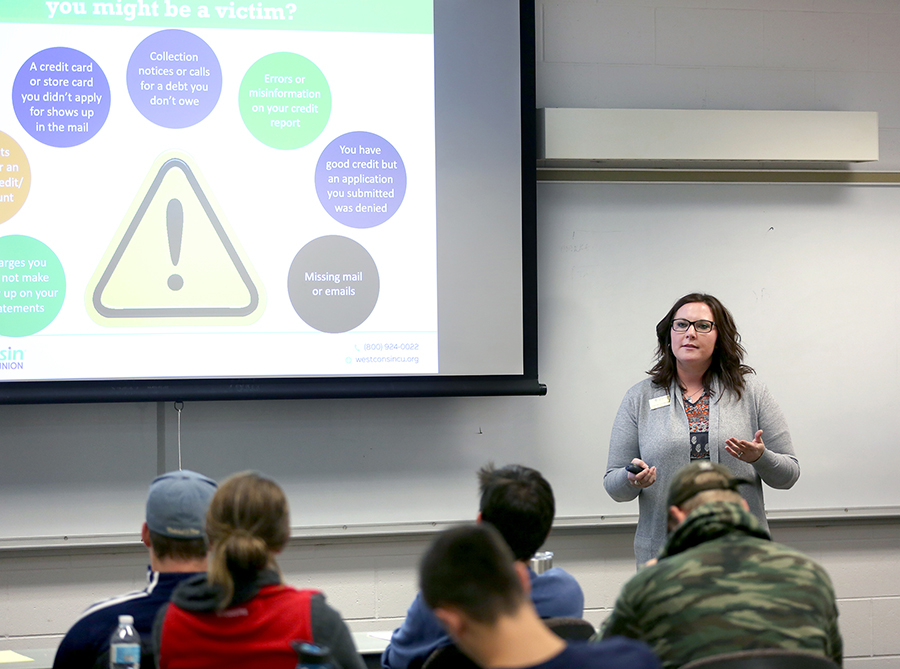 Chelse Cockeram, of WESTconsin Credit Union, presents information about identity theft and fraud to students in a Financial Wellness class.