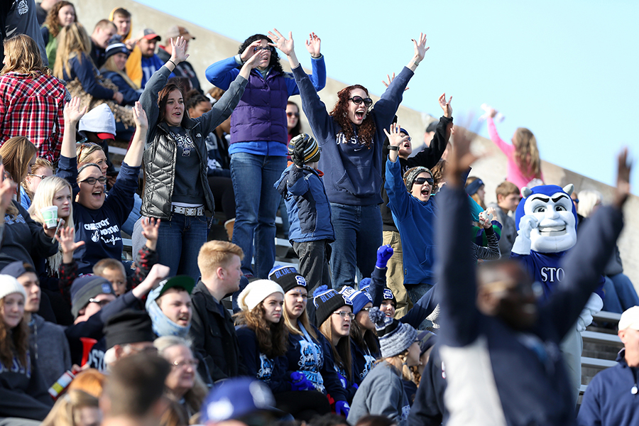 UW-Stout fans, including the mascot Blaze, cheer on the Blue Devil football team.