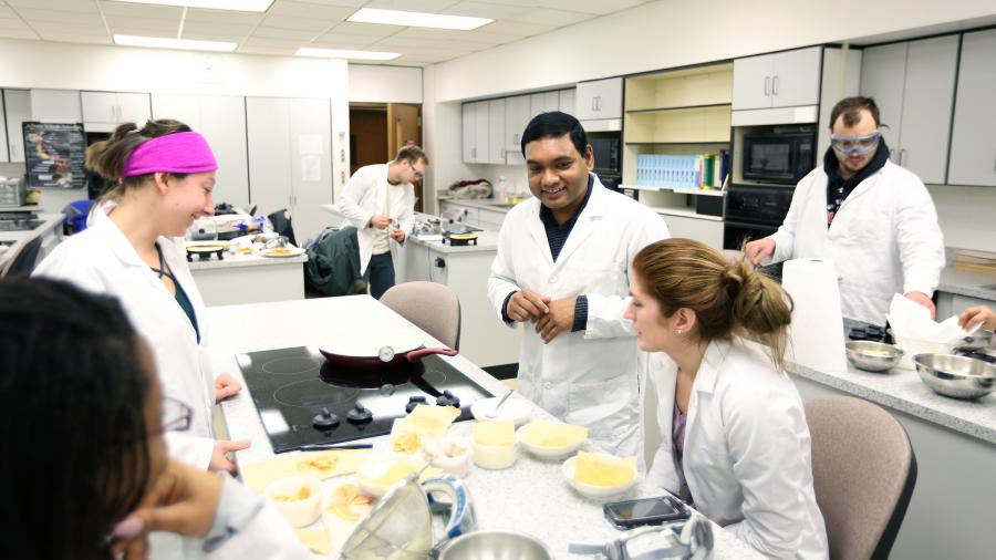 Assistant Professor Pranabendu Mitra, center, teaching a food science class lab in 2017.