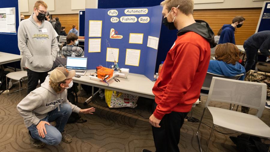Students demonstrate a fully automatic ice fishing rod and reel during the STEMM Student Expo.