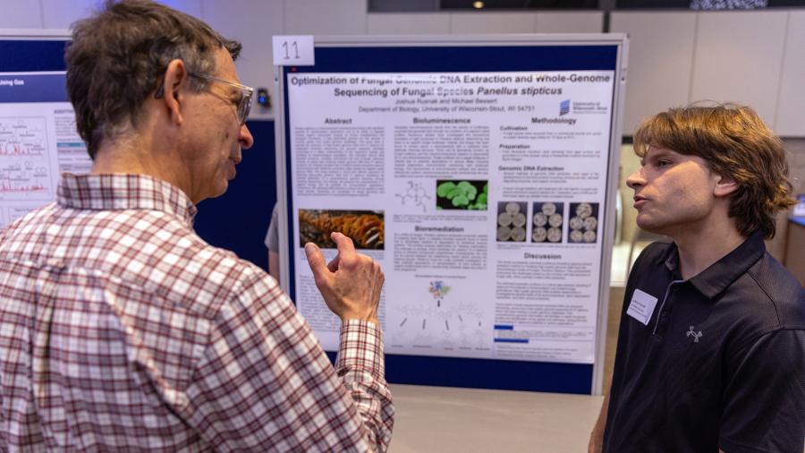 Joshua Rusnak talks about his research during Research Day on campus.