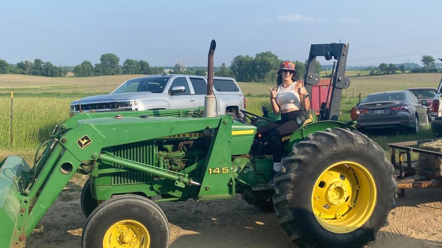 Genevieve on a tractor at Prestebak farm.