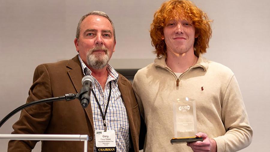UW-Stout student Gage Rusch receives the award in Scottsdale, Ariz., from the International Molded Fiber Association for winning the student design competition.