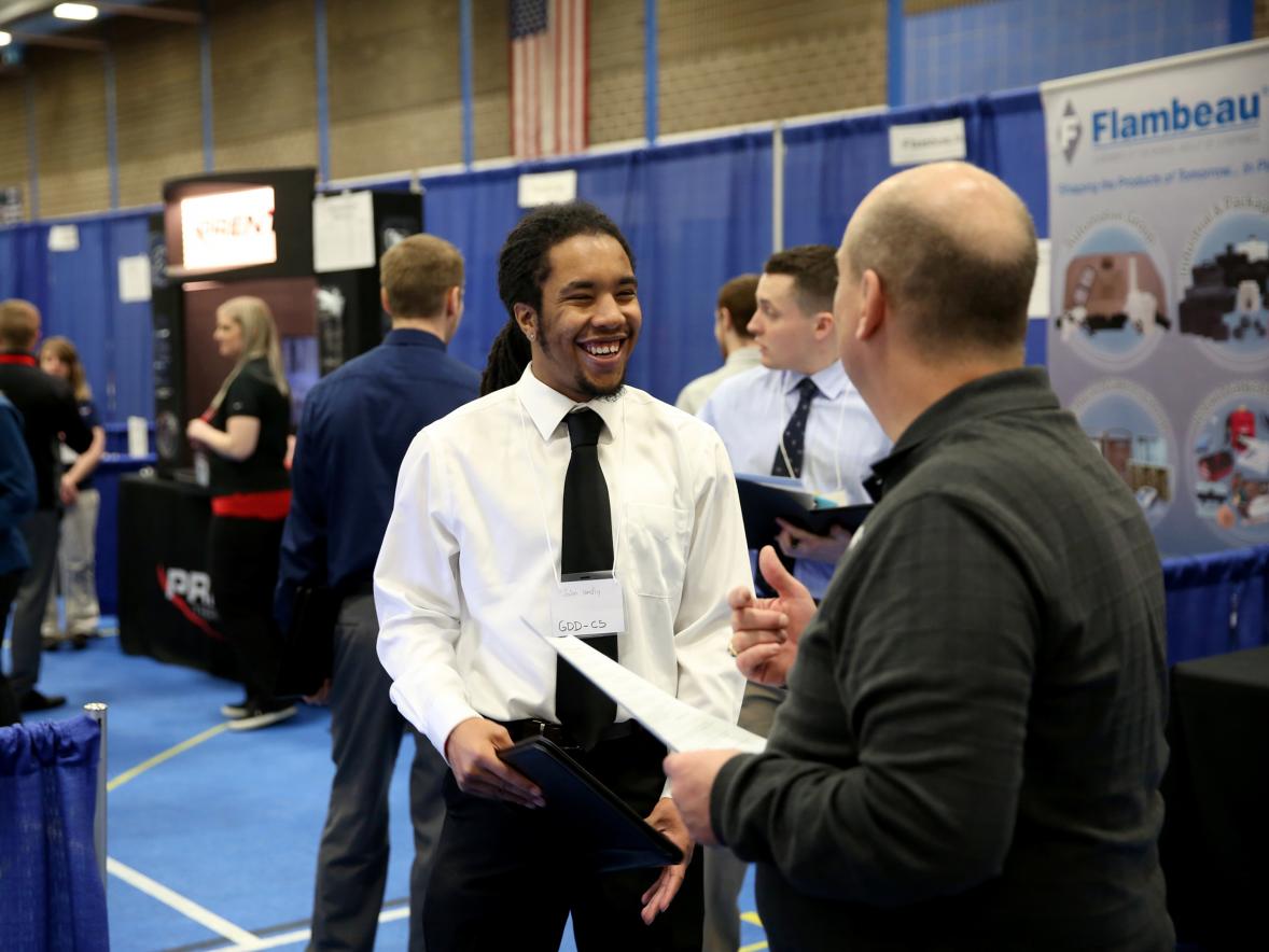 Jalen Hendley, a computer science-game design major from Flossmoor, Ill., visits with a recruiter at a 2017 Career Conference.