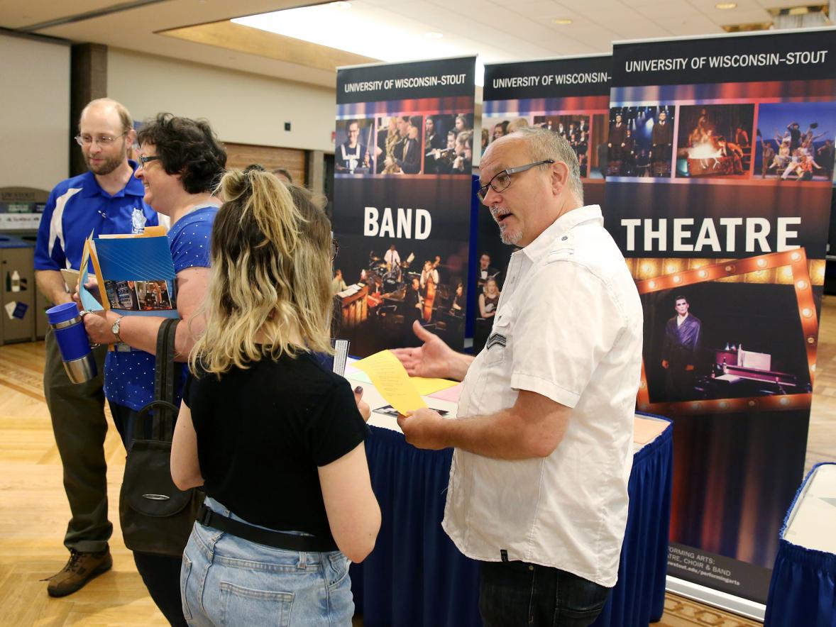 Paul Calenberg, who received a UW-Stout Diversity Award, talks with a student about University Theatre.