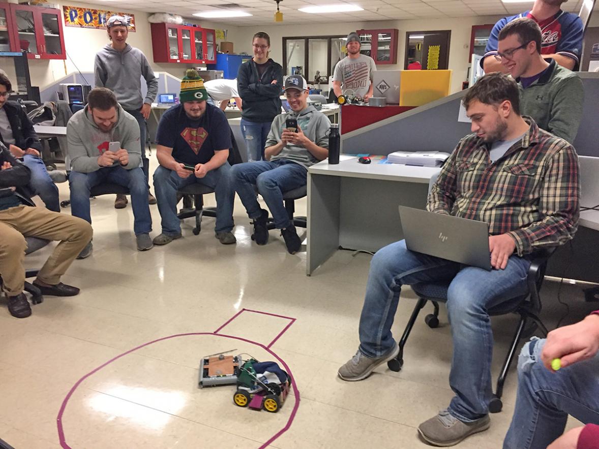 UW-Stout student Eli School uses a computer to drive his sumo robot and compete against another robot in the Mechatronics 371 class. 