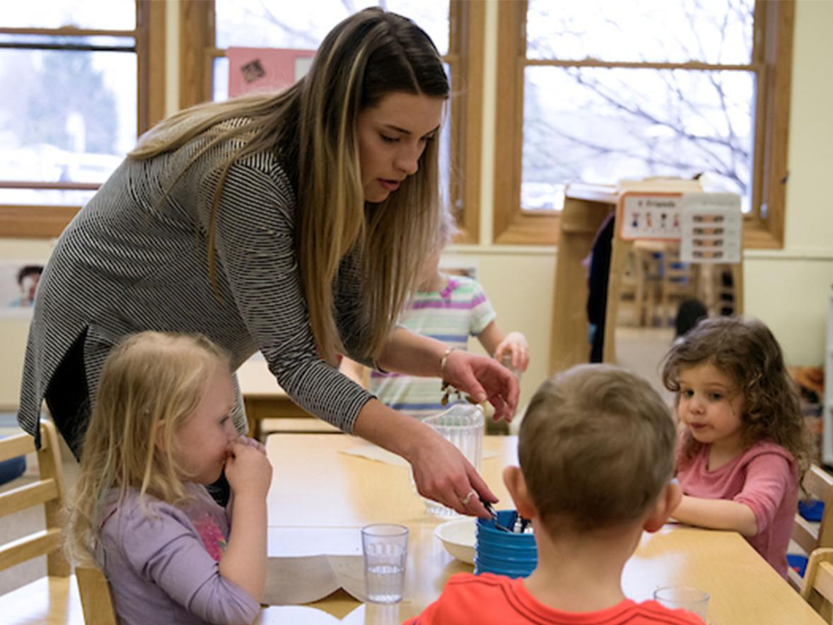 An early childhood education student works with preschoolers
