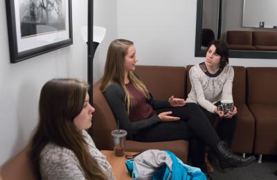 Students talk together on couch