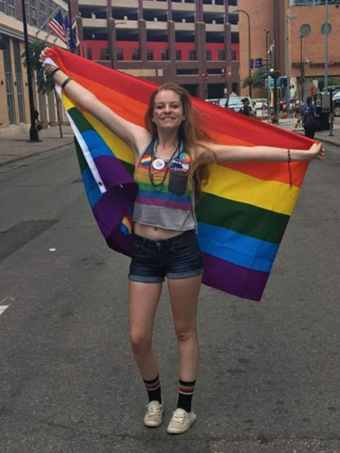 Kathryn Reeves, double major in art education and studio art, with a Gay Pride flag.