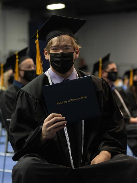 Richie Holder, environmental science major, smiles after receiving his diploma during commencement Dec. 18 at UW-Stout’s Johnson Fieldhouse.